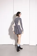 Buzo tipo canguro con cierre frontal parcial, cuello alto y diseño combinado con estampado animal print y paneles en color beige. Cuenta con puños elásticos y cordón ajustable en el ruedo.