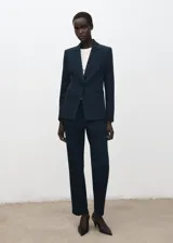 Pantalón estilo traje de corte recto y tiro medio, color azul marino, con bolsillos laterales y traseros, y cierre frontal oculto.