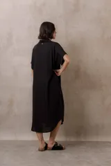 Vestido midi camisero de corte oversize color blanco, con cierre frontal de botones, mangas cortas con vuelta y ruedo redondeado.