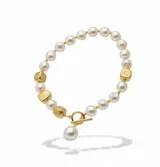 Collar corto de perlas sintéticas blancas intercaladas con cuentas metálicas en forma de cubo con acabado texturizado. Presenta un cierre frontal tipo T-bar con una perla colgante.