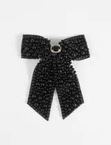 Broche moña negro con aplicaciones de perlas negras y strass.
