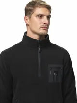 Buzo de polar gris oscuro con cuello alto y medio cierre frontal. Presenta un bolsillo en el pecho con cierre y detalles en nylon, además de bolsillos laterales con cierre.