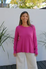 Sweater de punto color magenta, con cuello redondo, manga larga con puños acanalados y corte holgado.