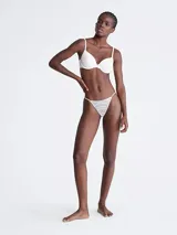 Colaless blanco con encaje elástico transparente y tiras delgadas.