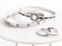 Pulsera rígida de acero quirúrgico color dorado con incrustaciones de circonias blancas.