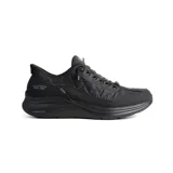 Championes deportivos Skechers Slip-ins de color negro, con diseño acolchado tipo puffer y tecnología Contour Foam en la entresuela. Presentan un sistema de calce fácil sin cordones funcionales, con cordones elásticos decorativos y refuerzos sintéticos en la puntera y el talón.