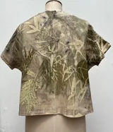 Vestido largo con estampado de hojas en tonos verdes y marrones.