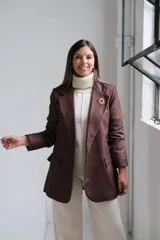 Blazer de corte sastrero en color marrón chocolate, con solapas clásicas, bolsillos delanteros con solapa y costuras a la vista en tono contrastante.