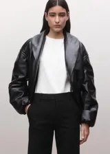 Pantalón de vestir negro estilo flare de tiro medio, con trabillas y cierre frontal con botón, gancho y cremallera.
