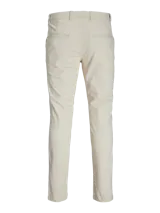 Pantalón chino slim de tiro medio en color beige, con cierre de cremallera y bolsillos laterales, confeccionado en tejido con algodón y elastano.