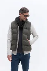Chaleco puffer de nylon con diseño matelaseado, cuello alto y cierre frontal. Cuenta con bolsillos laterales y un pequeño parche con logo en el pecho.