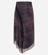 Pollera midi de tul con estampado a cuadros, diseño con abertura lateral decorada con encaje y bajo asimétrico en pico. Cuenta con cintura elástica y forro interior.