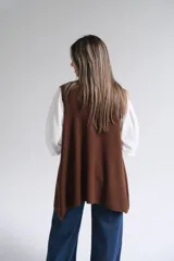 Chaleco largo abierto de tejido de punto color chocolate, con bolsillos frontales aplicados y diseño sin mangas.