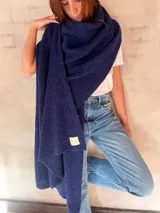 Chal de punto bouclé color marrón claro, hecho de 100% baby alpaca. Tejido suave, esponjoso y cálido, ofrece una textura envolvente y lujosa.