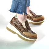 Zapatos deportivos urbanos de cuero, con diseño animal print de leopardo, elásticos laterales y suela de plataforma alta con capas en tonos marrón, blanco y tostado.
