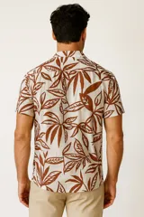 Camisa de manga corta con cuello tipo cubano, confeccionada en viscosa con estampado de hojas en tonos azul y blanco.