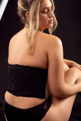 Corset corto negro con copa y aro, confeccionado en microtul y lycra reforzada. Breteles desmontables y regulables.