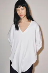 Camiseta tipo capa color negro de algodón Supima 100%, con escote en V, manga larga fluida y bajo asimétrico.