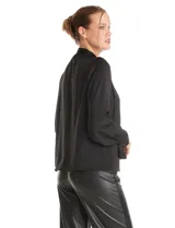 Blusa negra de acabado satinado con cuello alto fruncido, detalle de lazo para anudar y cierre lateral con botones. Presenta mangas largas estilo balloon con puños ajustados.