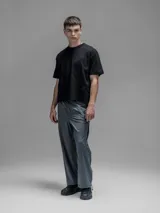 Pantalón cargo de corte oversize confeccionado en microfibra técnica. Presenta cintura elástica, bolsillos laterales y un bolsillo cargo con cierre de broche snap. Incluye un sistema de elásticos con tancas en los tobillos para regular la apertura y la silueta.