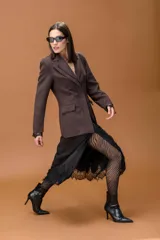 Falda midi de color negro con diseño irregular y terminación en encaje delicado en el ruedo.