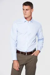 Camisa celeste de vestir, entallada, de manga larga, con cuello clásico y sin bolsillo.