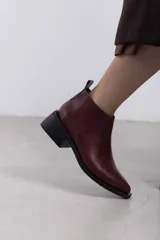 Botineta de cuero negro con textura sutil, con elásticos laterales y taco cuadrado bajo.