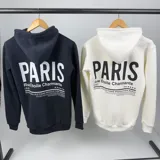 Canguro negro de algodón con capucha, medio cierre frontal y estampa blanca con la palabra "Paris".