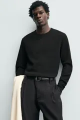 Camiseta relaxed fit de manga larga y cuello redondo, confeccionada en tejido de algodón con estructura waffle en color negro.