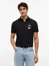 Chomba de algodón elástico con cuello polo y cartera de tres botones. Presenta un diseño de corte regular con cuello y puños de punto canalé, destacando por el logo colaborativo de Tommy Hilfiger y Cadillac Formula 1 en el pecho.