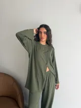 Conjunto de dos piezas color gris melange, confeccionado en tela de lanilla, compuesto por un buzo de manga larga con diseño cruzado al frente y un pantalón largo de corte holgado y tiro alto.