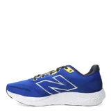 Championes de running New Balance, color azul con detalles en amarillo, azul marino y blanco. Presentan tecnología Fresh Foam en la entresuela, logo N lateral en plateado y suela de goma negra.