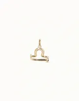 Dije dorado con forma del signo zodiacal Libra.