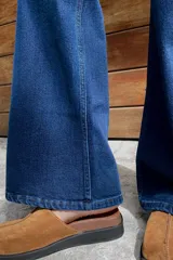 Pantalón de jean azul oscuro, corte wide leg y tiro medio alto.