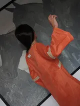 Vestido corto negro con detalles en color crema, escote en V y mangas acampanadas.