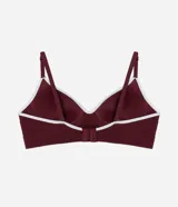Soutien tipo bralette de color blanco hueso, sin costuras (seamless), con copas moldeadas y escote en V. Presenta una banda ancha elástica bajo el busto para mayor soporte y tirantes finos ajustables.