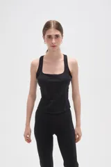 Musculosa deportiva de poliamida, color negro, con cuello cuadrado y breteles anchos. Diseño ajustado al cuerpo con costuras laterales visibles.