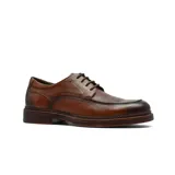 Zapato de vestir tipo derby en cuero color marrón con acabado envejecido, cordones al tono y suela de cuero con detalle de costura vista.