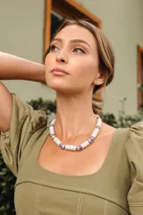 Collar corto de cerámica y cristal checo, compuesto por cuentas cilíndricas blancas intercaladas con piezas de cerámica blanca decoradas con motivos florales azules.
