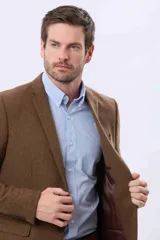 Saco sport de lana en color marrón, con diseño clásico de solapa tradicional, estructura definida y cierre frontal con botones.