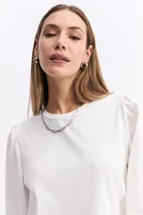 Remera de algodón con cuerpo liso y mangas largas abullonadas en popelina, con puños elásticos fruncidos.