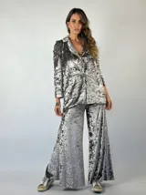 Blazer gris de terciopelo con solapas y cierre frontal con un botón. Presenta un patrón de matices sutiles en la tela.