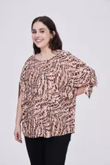 Blusa estampada con cuello redondo y mangas cortas con aberturas.