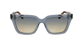 Lentes de sol Lacoste modelo 6063, color gris azulado con lentes degradadas de gris a amarillo. Patillas con estampado carey.