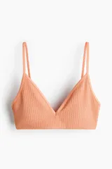 Top de bikini con textura, color salmón, escote en V y tirantes finos ajustables.