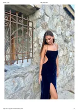 Vestido largo midi de terciopelo azul marino, con breteles de cadena plateada, espalda descubierta, corte ajustado y tajo lateral.