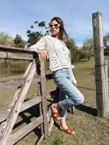 Sweater calado color crudo, de manga larga y cuello redondo.