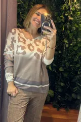 Buzo de lanilla con estampado animal print en la parte superior, cuello redondo y mangas largas con puños en contraste. Presenta un diseño degradado con franjas horizontales en la parte inferior.