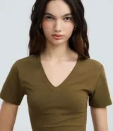 Blusa de corte regular confeccionada en algodón con elastano, con escote en V, mangas cortas y diseño liso.