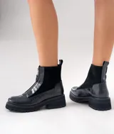 Botas cortas de cuero vacuno con textura de reptil, diseño con cierre frontal y suela de plataforma dentada de caucho.